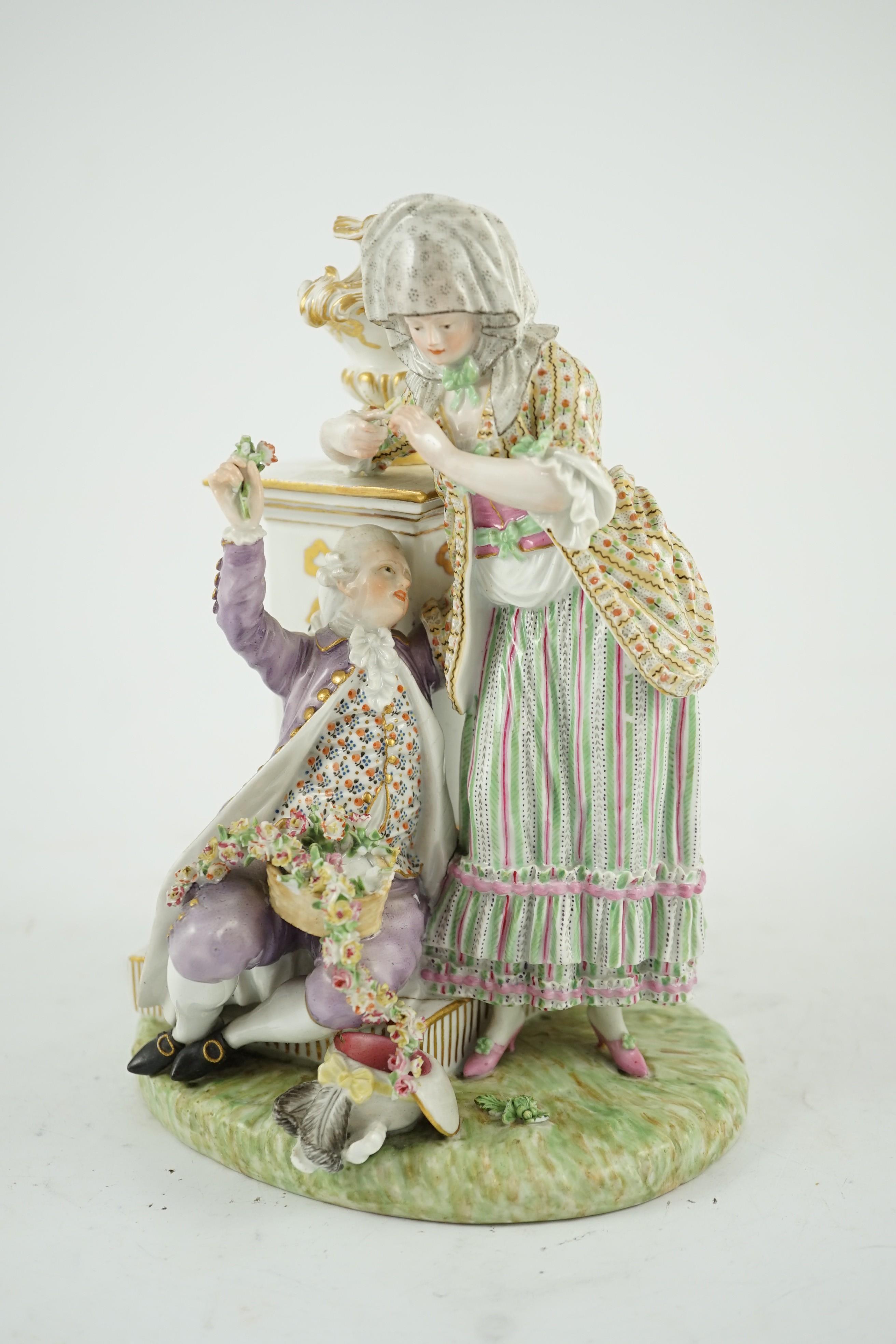 A Meissen porcelain group of a maid and a gallant by a pedestal, 19th century, 22cm high, crack to base